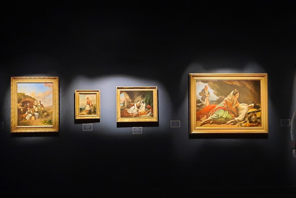 Gallery room with paintings in dark blue background