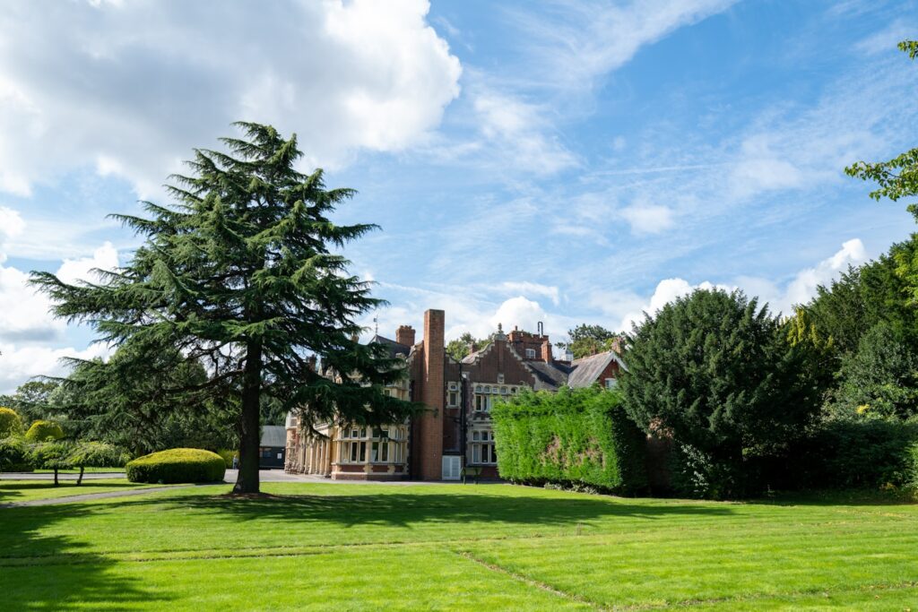 a large house sitting on top of a lush green field