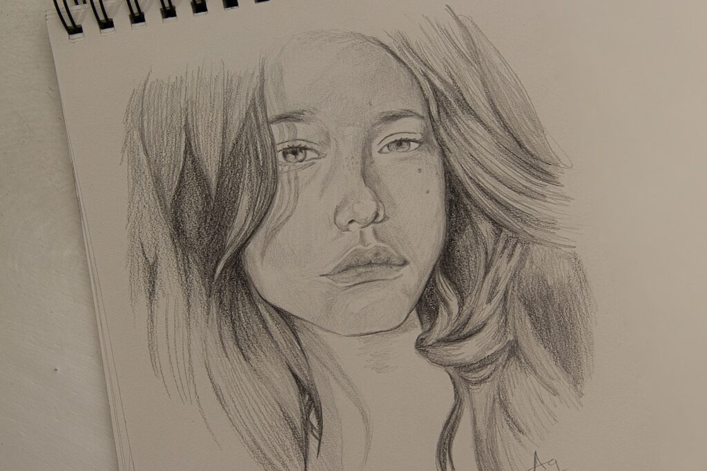 womans face sketch on white paper