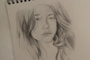 womans face sketch on white paper