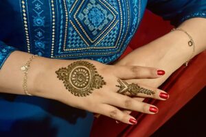 a woman's hand with henna tattoos on it